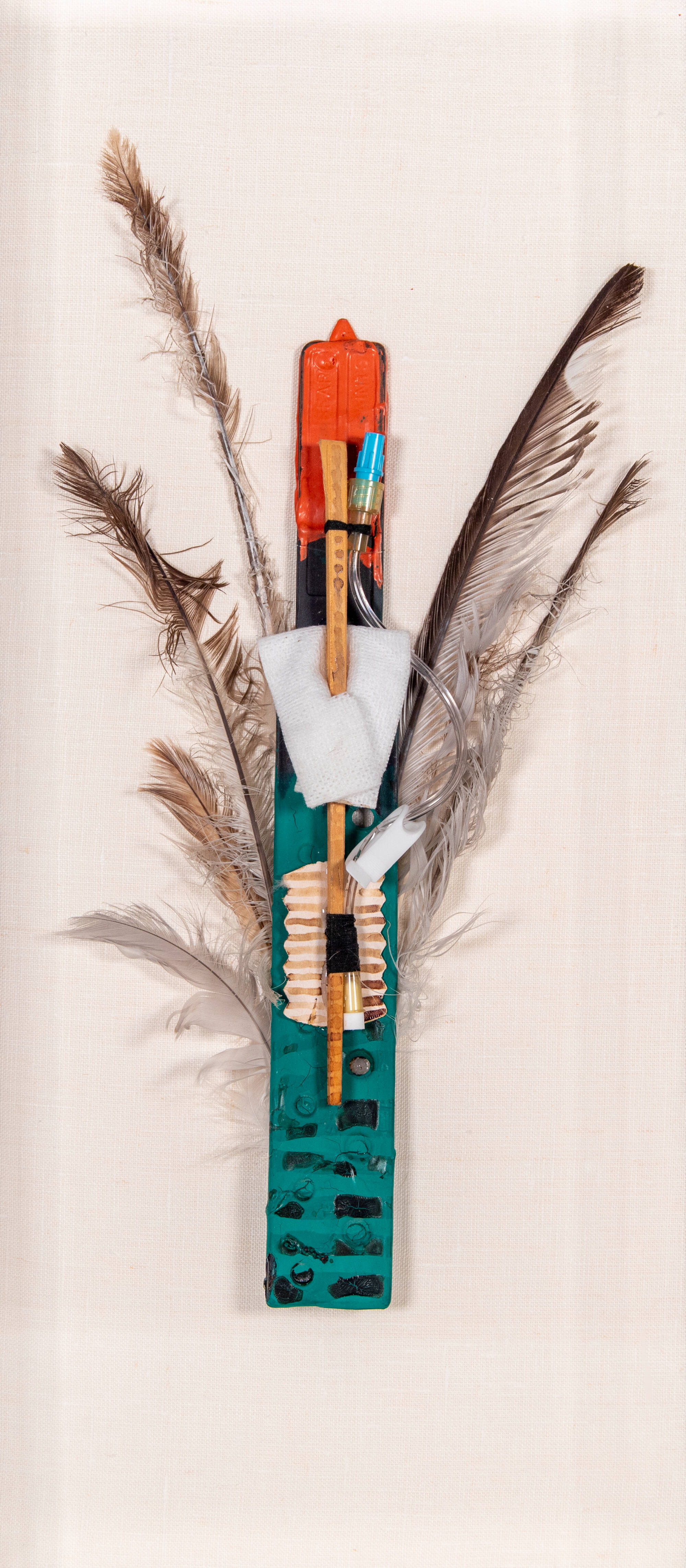 Mixed media sculpture that looks like a person with feather wings.